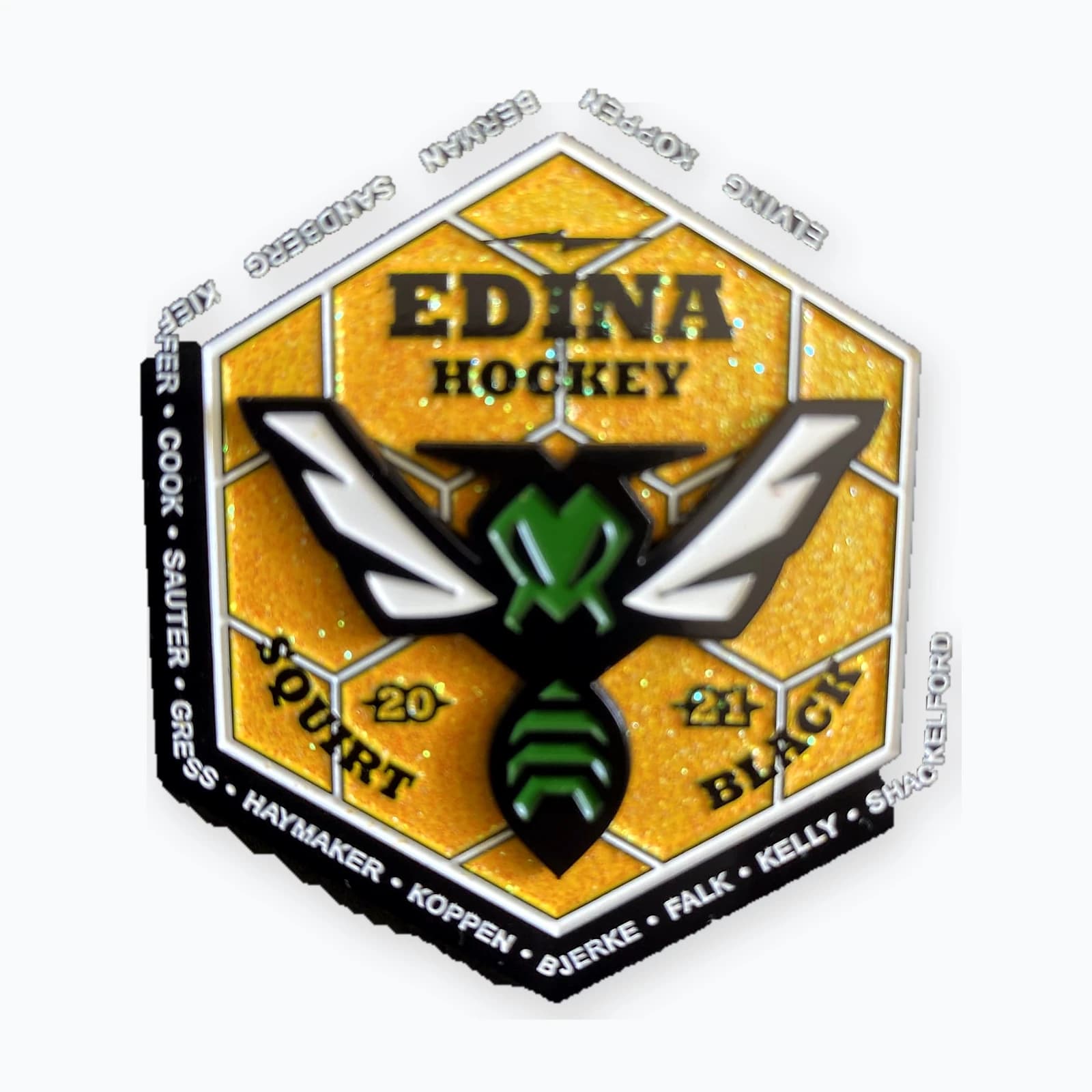 An Edina hockey trading pin with a hornet mascot