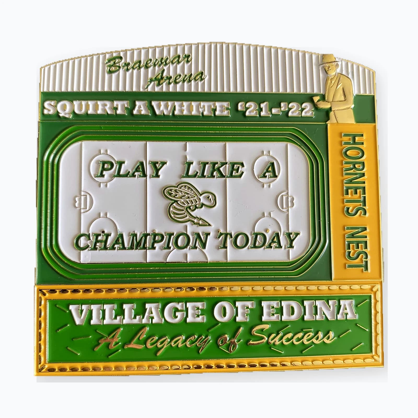 An Edina Squirt A White trading pin reading Play Like A Champion Today