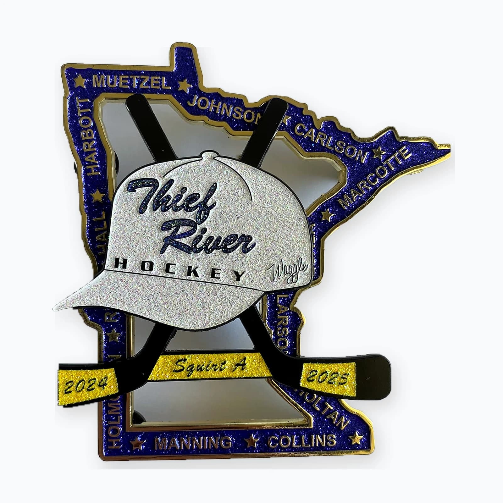 A Minnesota-shaped Thief River hockey trading pin