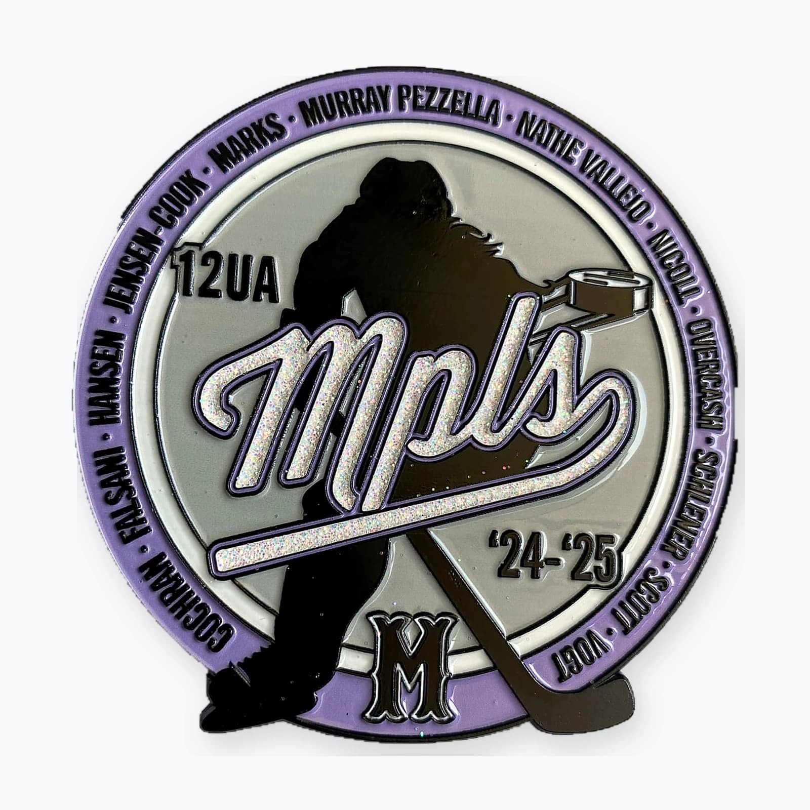A Minneapolis 12UA trading pin with a player silhouette