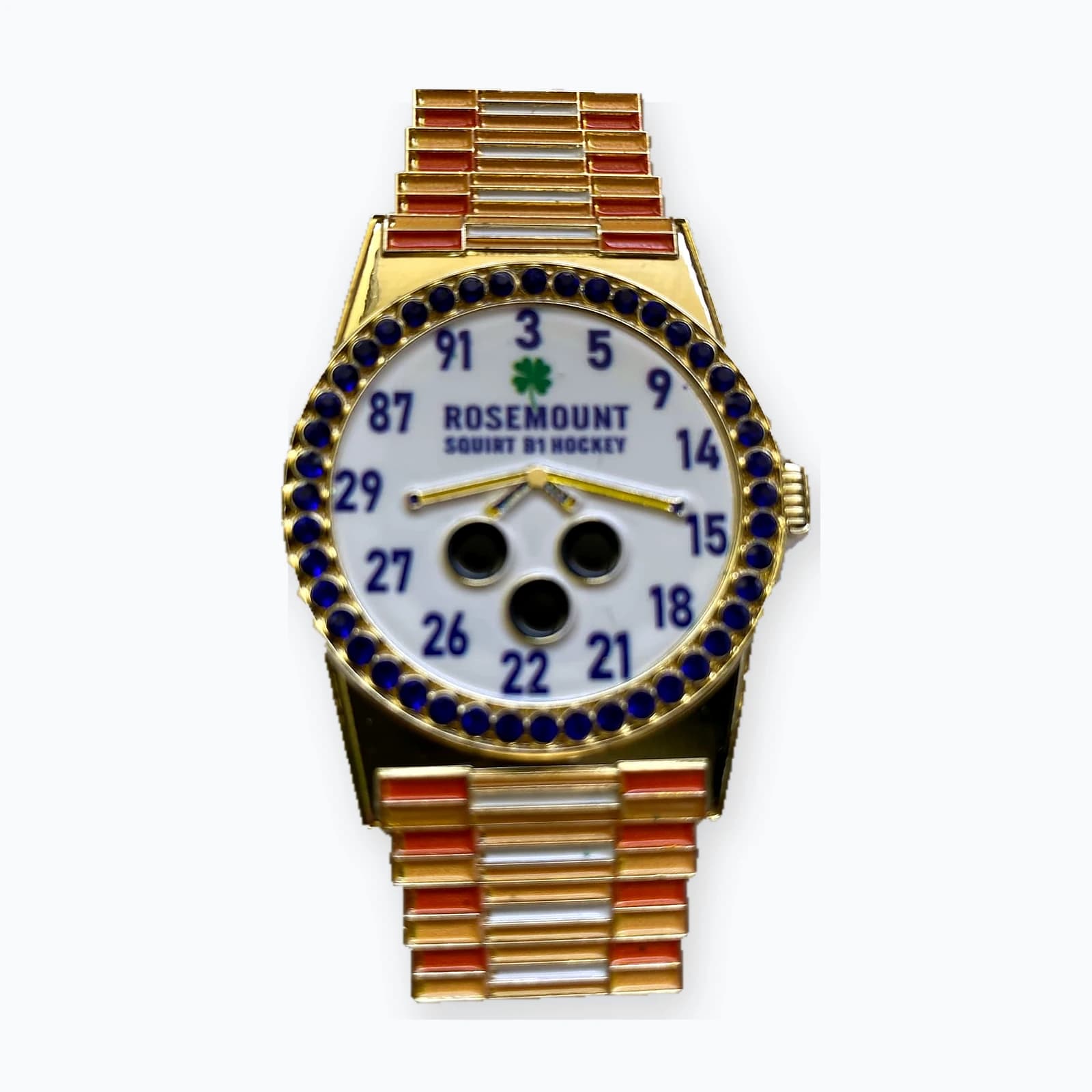 A trading pin shaped like a wristwatch with player numbers on the face