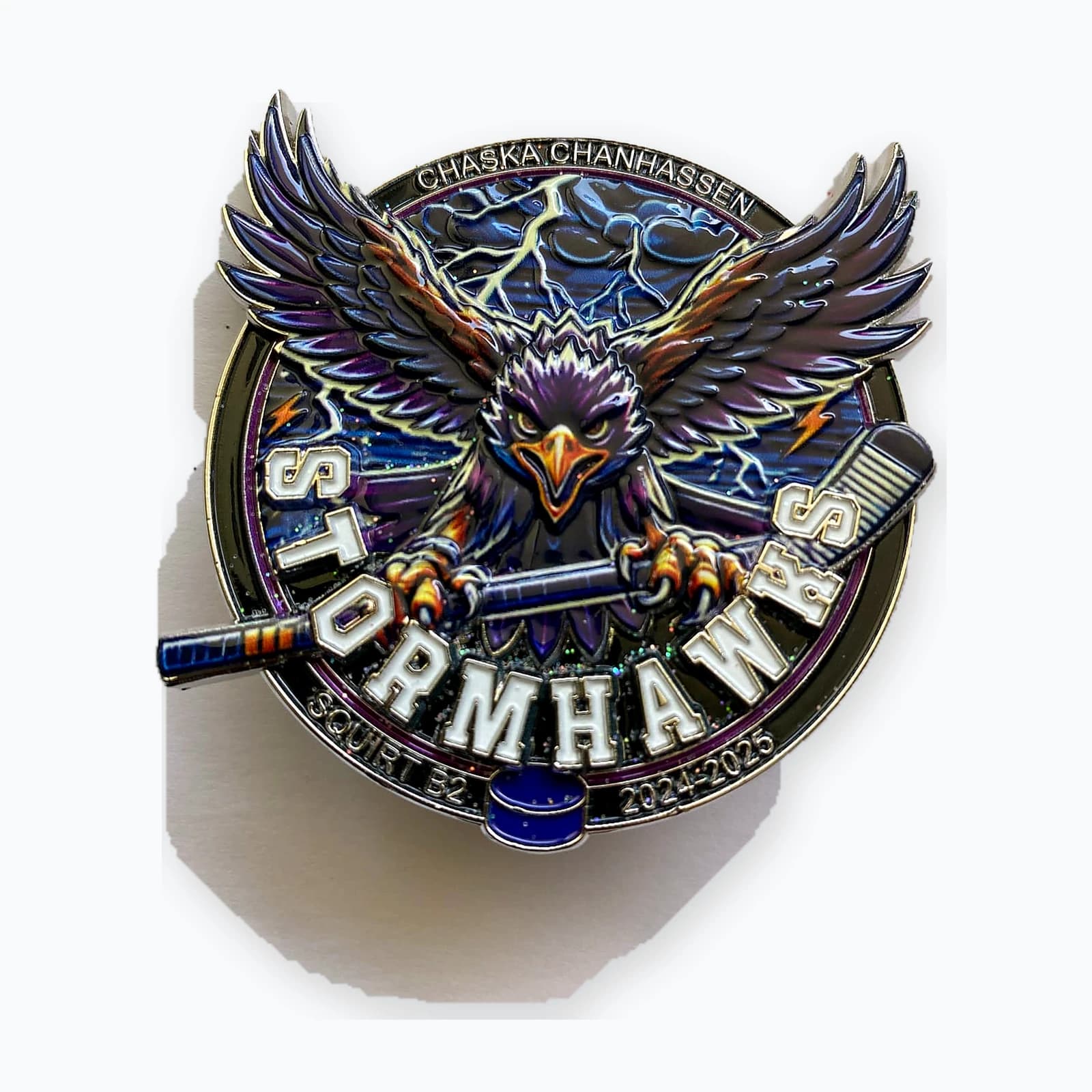 A trading pin shaped like a hawk with spread wings