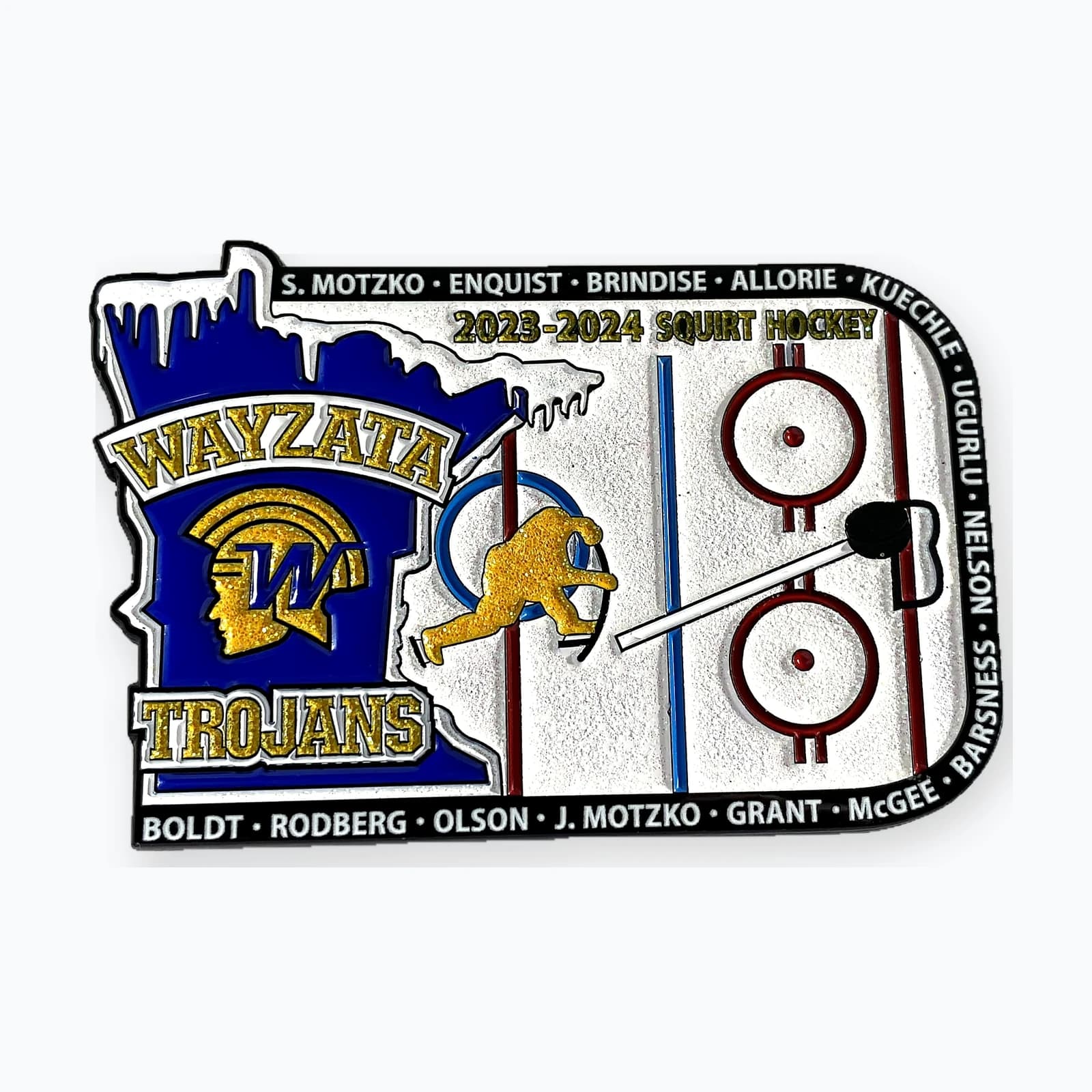 A Wayzata Trojans trading pin shaped like Minnesota, with a puck that slides along a stick across a glittered ice surface